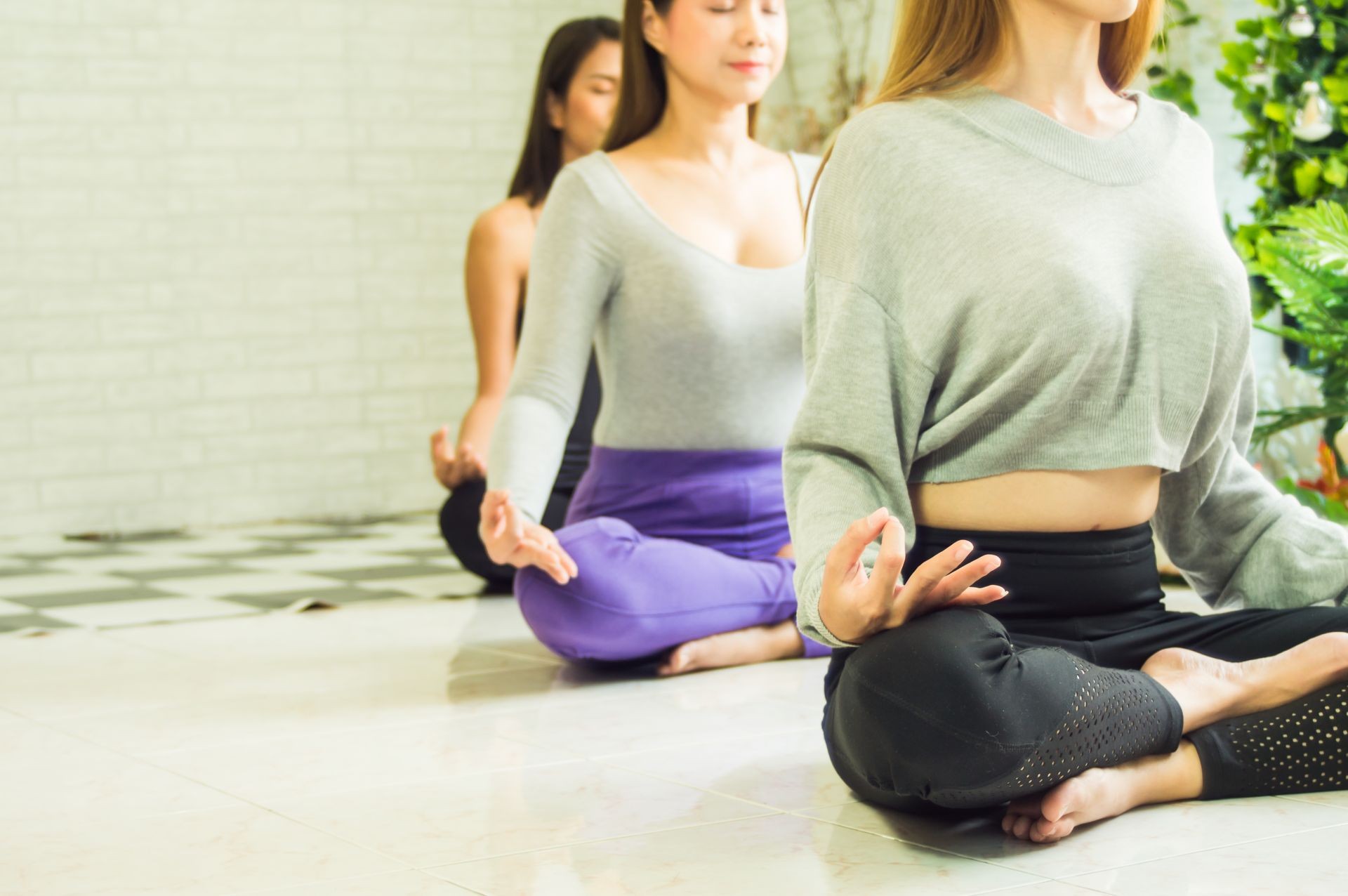Group of beautiful women in yoga and meditation classes to refresh the mind and spirit, with  concept of relaxation and body and mind development from fatigue from work to nature.